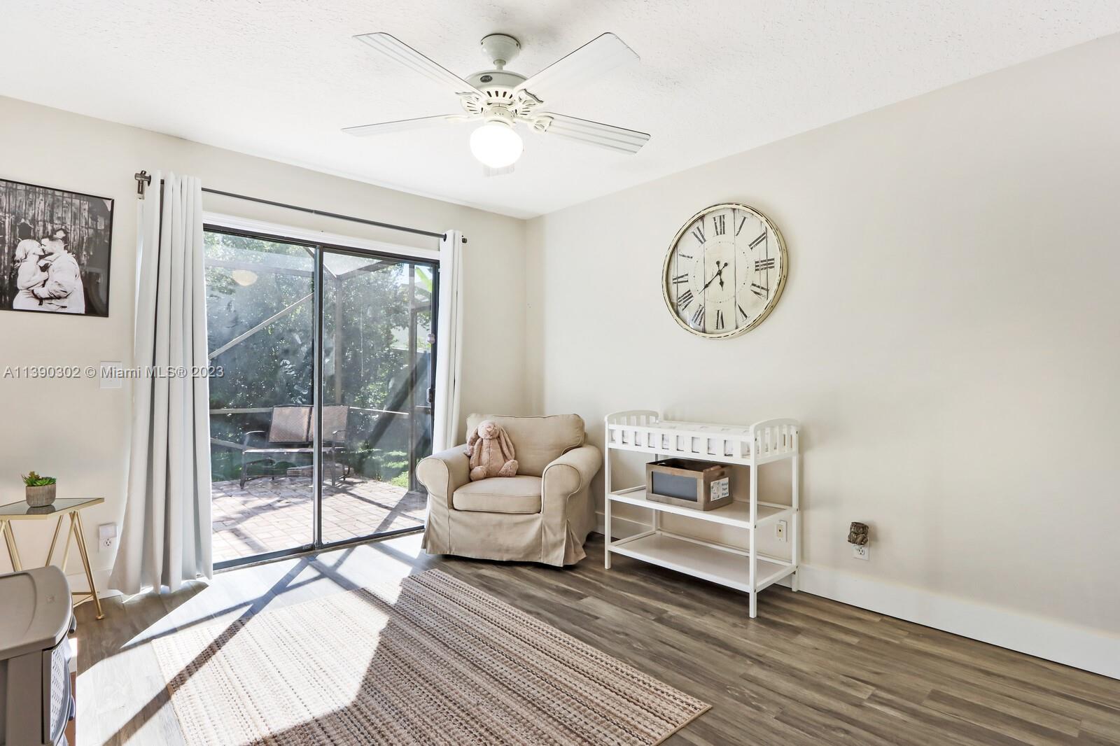 6122 Adams Street Jupiter, FL 33458 - Photo 21 of 59 a living room with couch and a large window