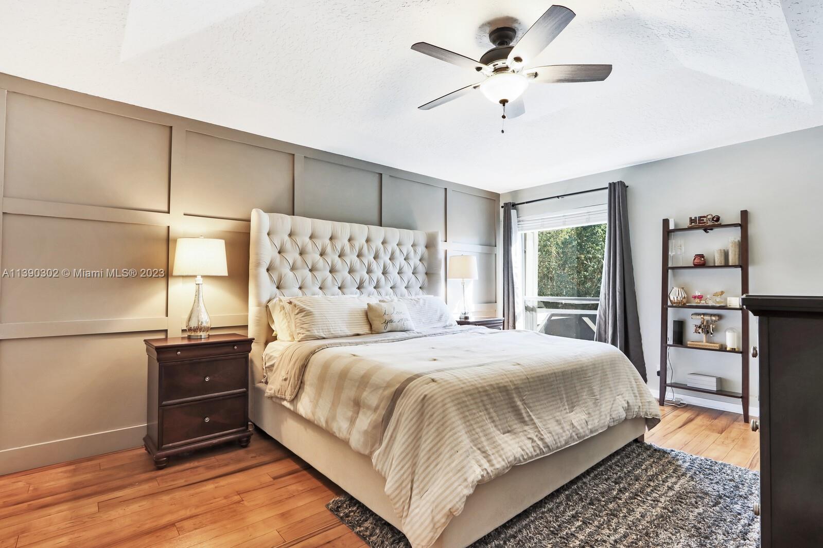 6122 Adams Street Jupiter, FL 33458 - Photo 22 of 59 a bedroom with a bed and a chandelier