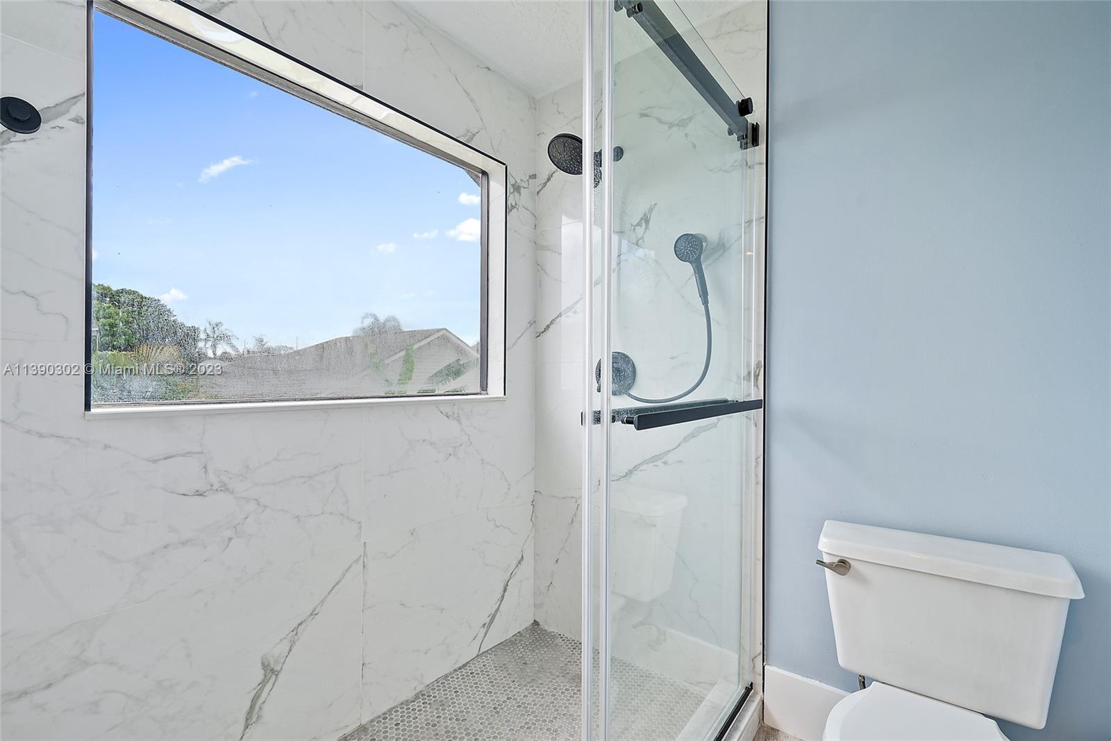 6122 Adams Street Jupiter, FL 33458 - Photo 26 of 59 a bathroom with a granite countertop shower and a toilet