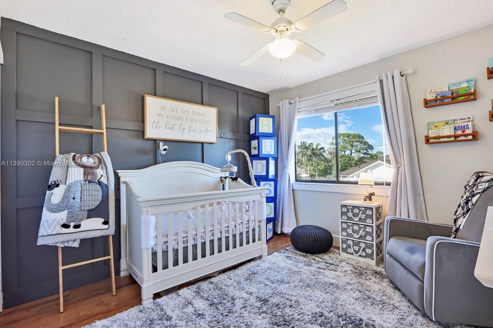 6122 Adams Street Jupiter, FL 33458 - Photo 29 of 59 a bedroom with a bed and a window
