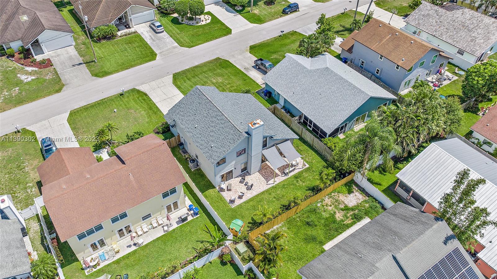 6122 Adams Street Jupiter, FL 33458 - Photo 36 of 59 an aerial view of a house with a yard