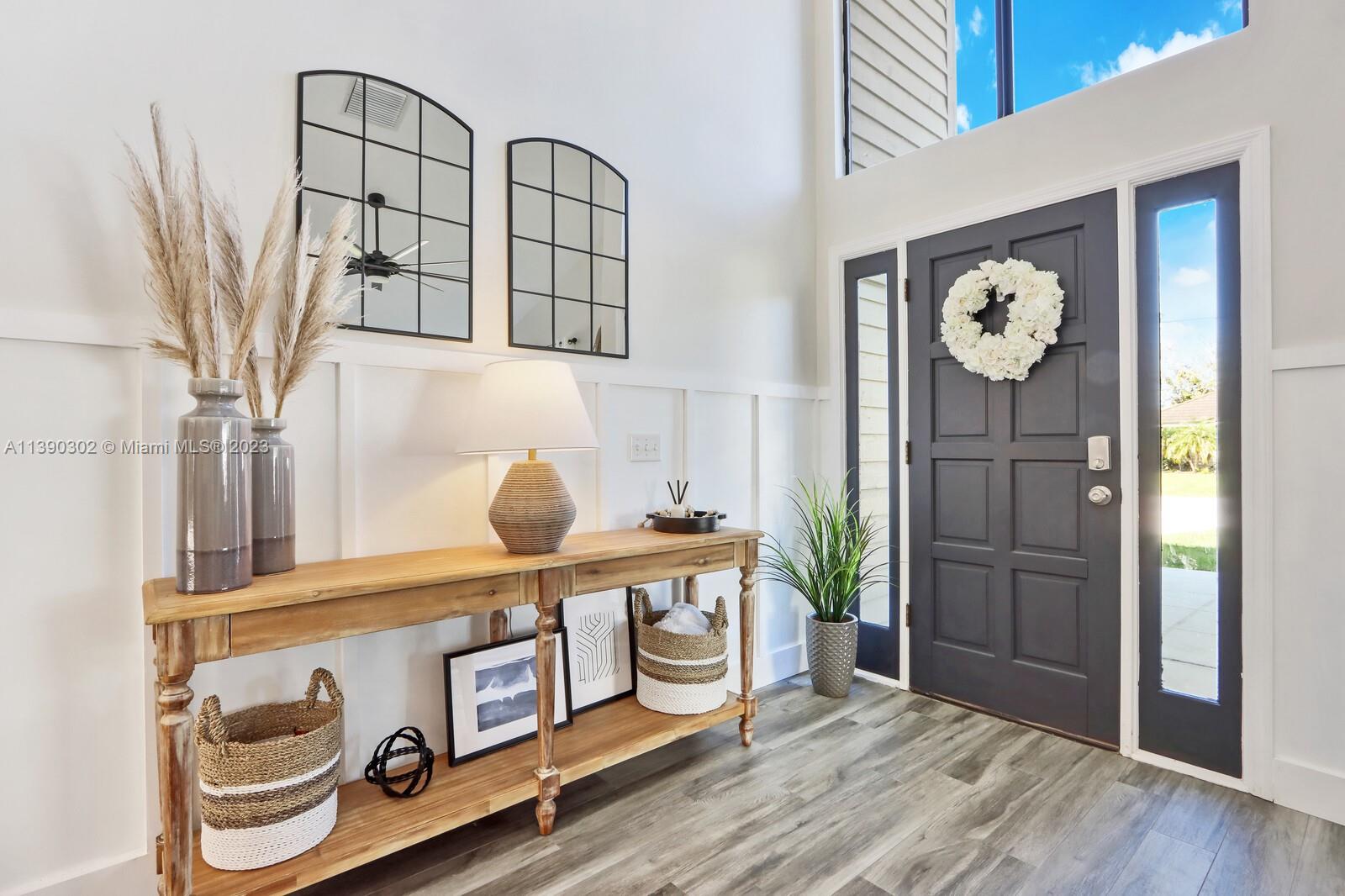 6122 Adams Street Jupiter, FL 33458 - Photo 4 of 59 a view of entryway with wooden floor