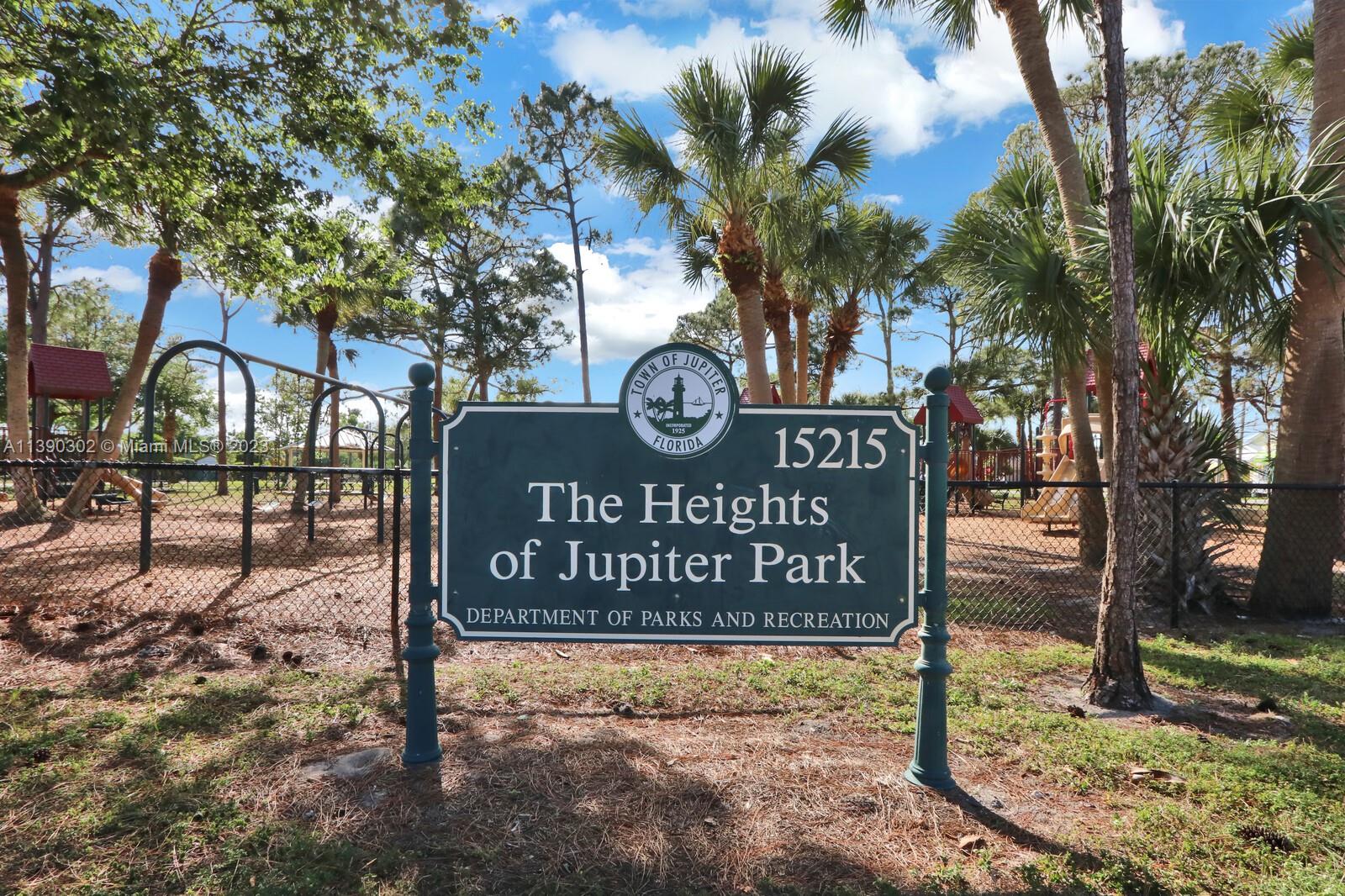6122 Adams Street Jupiter, FL 33458 - Photo 41 of 59 a view of street sign under a large tree
