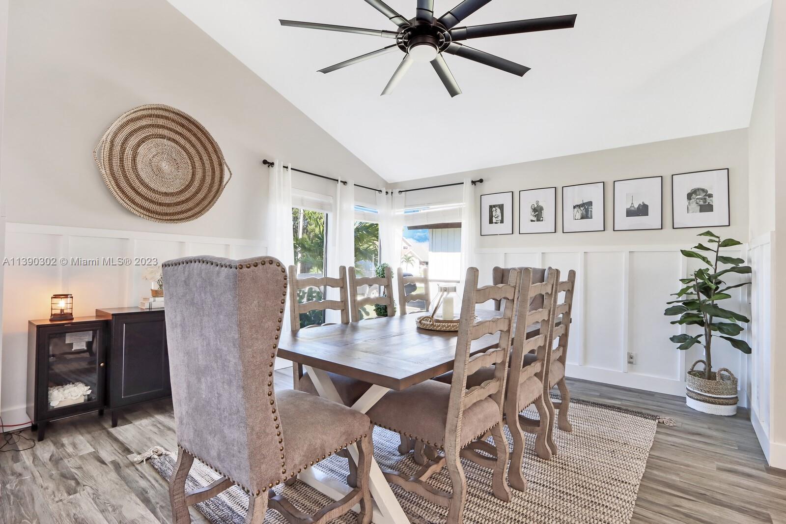 6122 Adams Street Jupiter, FL 33458 - Photo 5 of 59 a view of a dining room with furniture and wooden floor