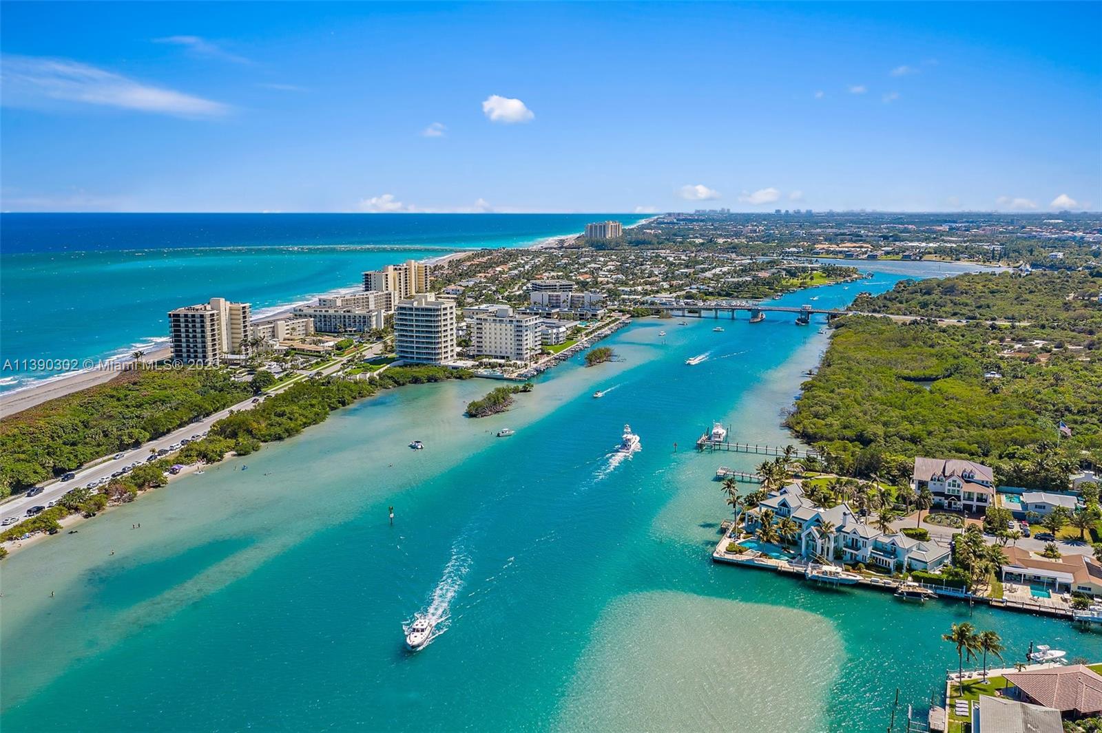 6122 Adams Street Jupiter, FL 33458 - Photo 54 of 59 an aerial view of a city with a lake view