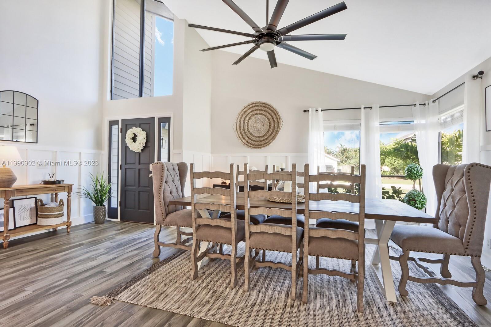 6122 Adams Street Jupiter, FL 33458 - Photo 6 of 59 a view of a dining room with furniture window and wooden floor