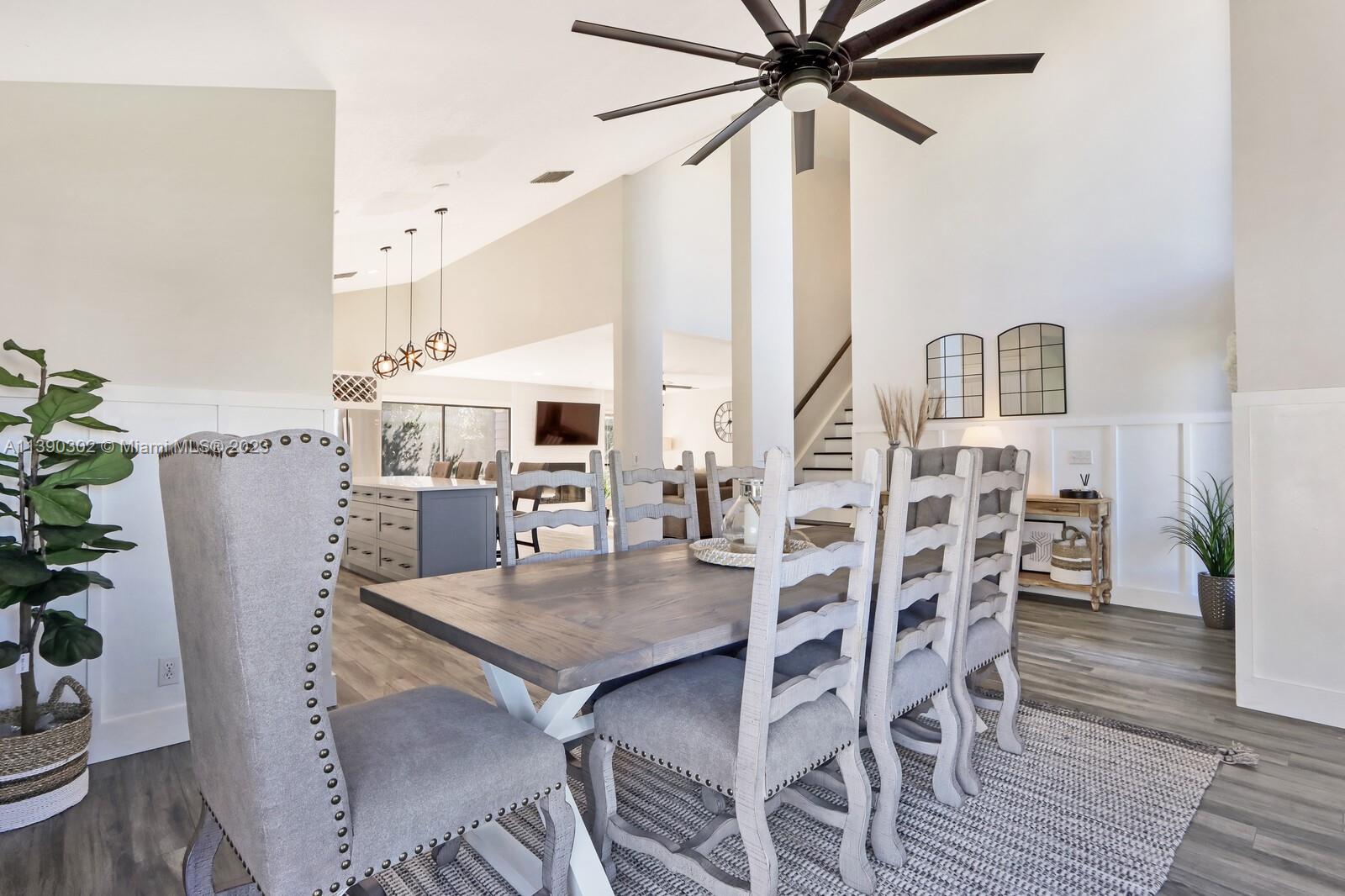 6122 Adams Street Jupiter, FL 33458 - Photo 7 of 59 a view of a dining room with furniture and wooden floor