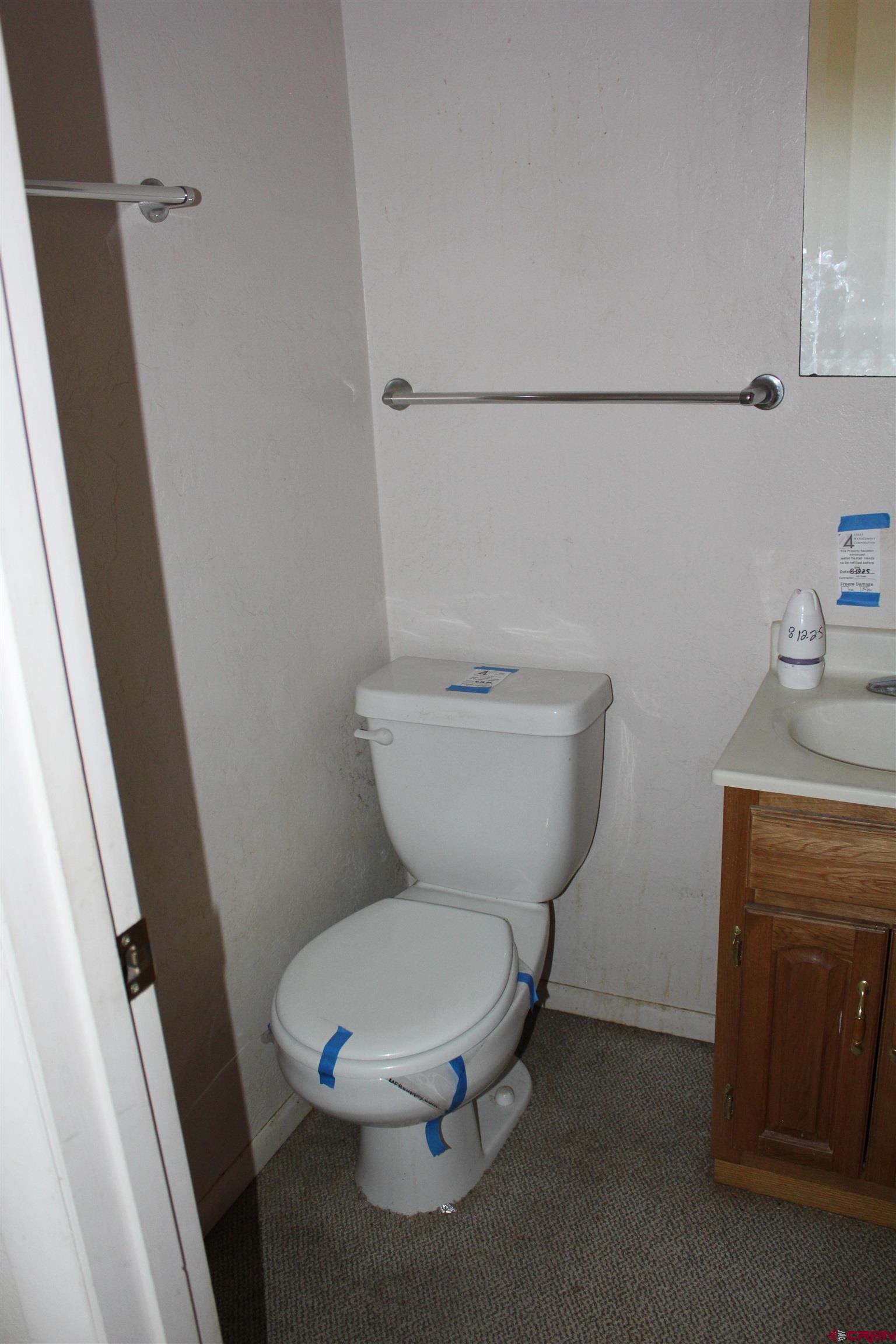 23892 County Rd M Cortez, CO 81321 - Photo 15 of 27 a white toilet sitting next to a sink and vanity