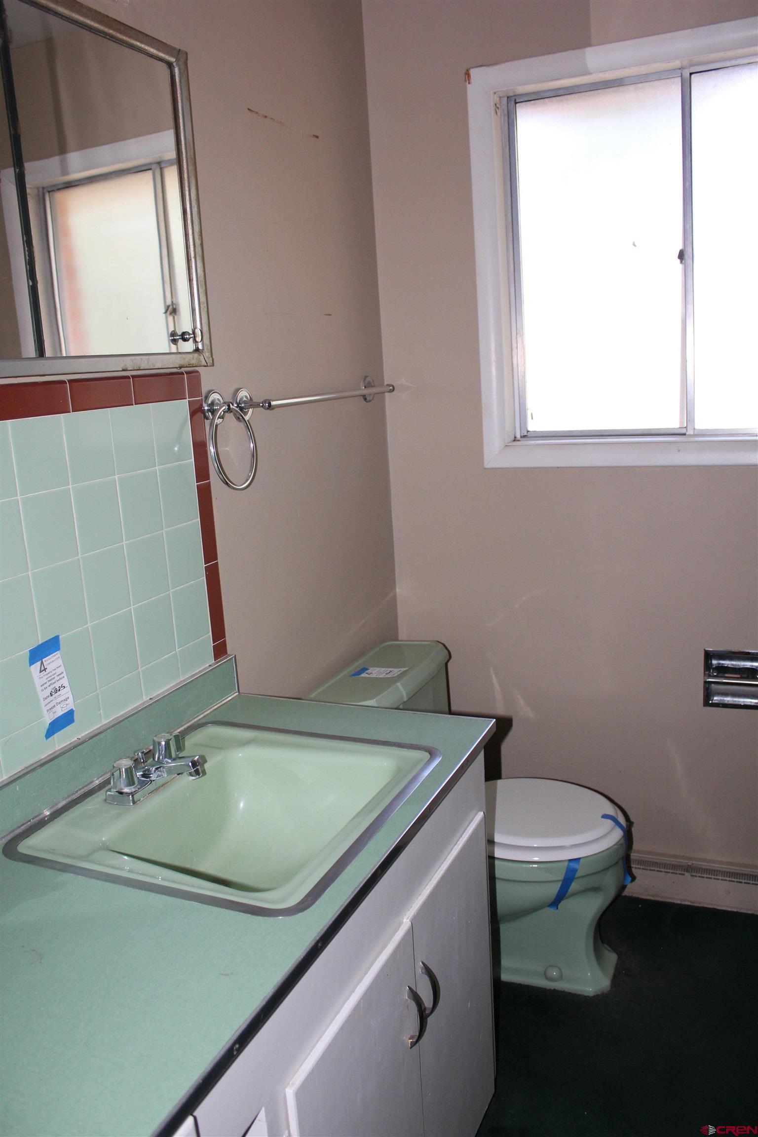23892 County Rd M Cortez, CO 81321 - Photo 7 of 27 a bathroom with a granite countertop sink a toilet and shower