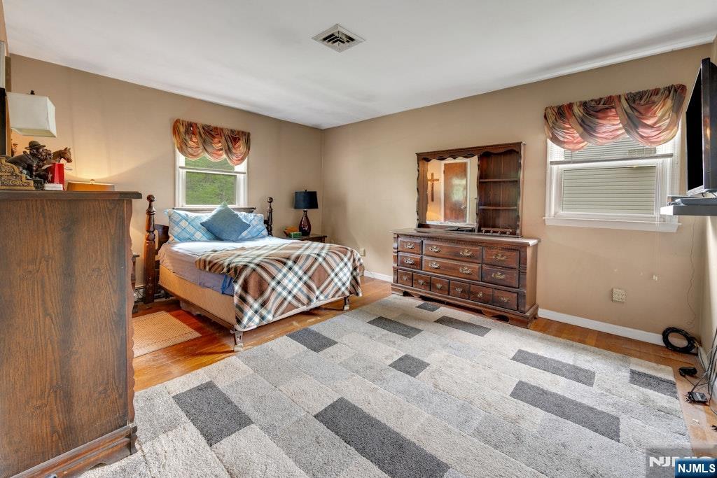 185 Ratzer Road Wayne, NJ 07470 - Photo 28 of 36 a bedroom with a bed and furniture