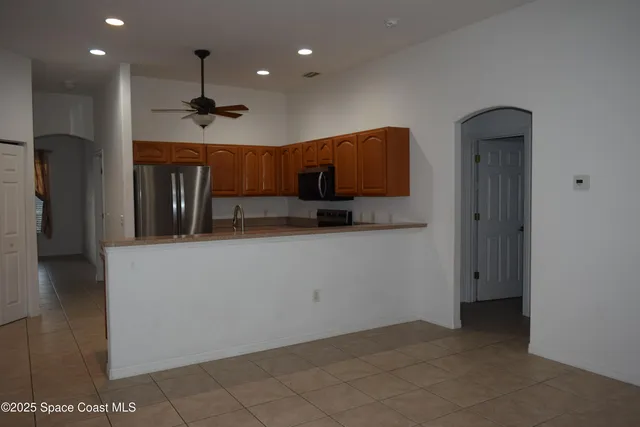a kitchen with stainless steel appliances granite countertop a refrigerator and a sink