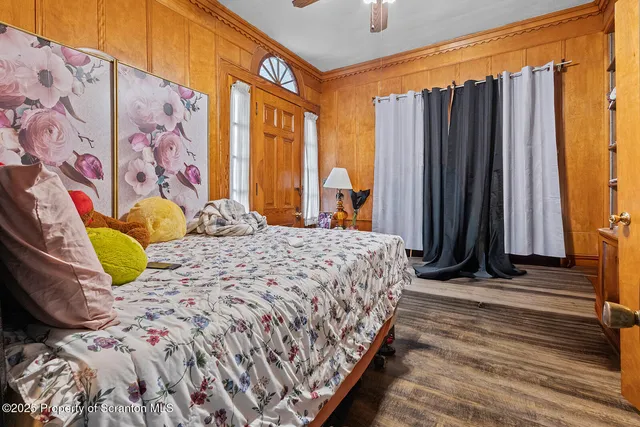 a bedroom with a bed and a painting on the wall