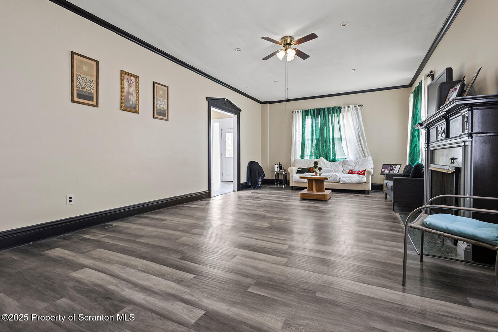 511 Fig Street Scranton, PA 18505 - Photo 12 of 33 a view of a livingroom with furniture hardwood floor and a ceiling fan