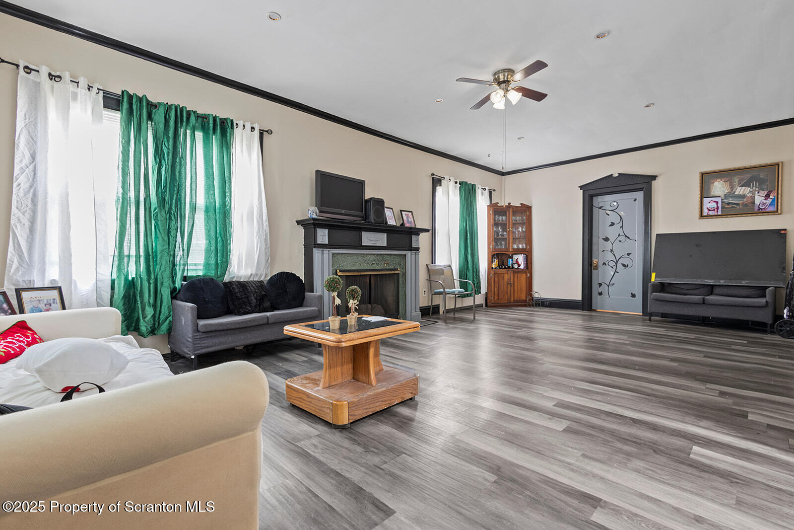 511 Fig Street Scranton, PA 18505 - Photo 13 of 33 a living room with furniture a fireplace and a flat screen tv