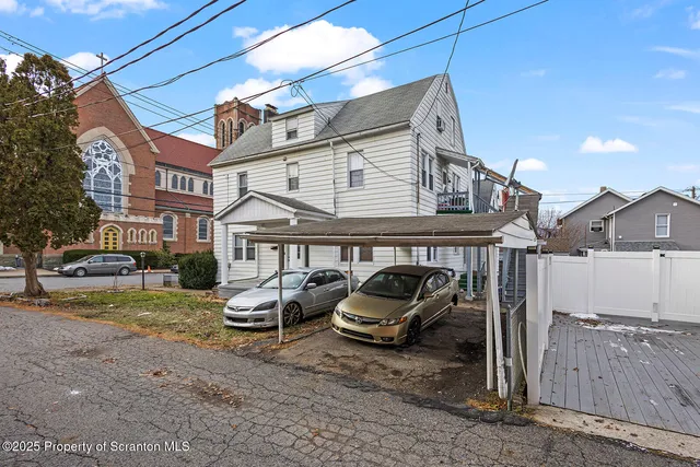 a view of a car park in front of house