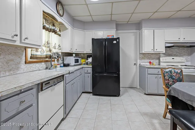 a kitchen with a sink appliances and cabinets