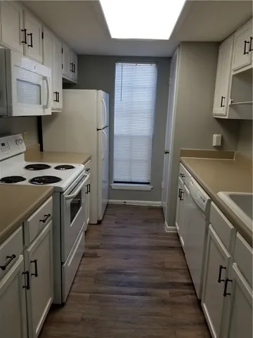 a kitchen with granite countertop a refrigerator and a stove
