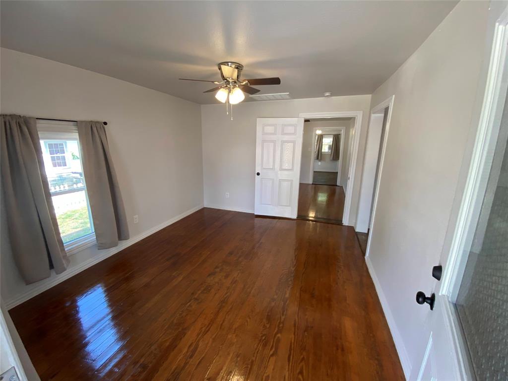 810 Greenville Road McKinney, TX 75069 - Photo 4 of 21 wooden floor in an empty room with a window