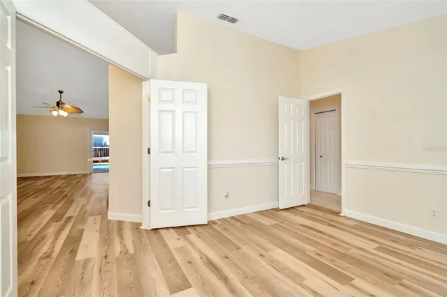 a view of a room with wooden floor