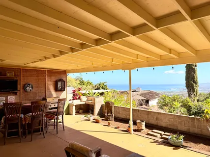 a kitchen with stainless steel appliances a dining table chairs refrigerator and sink