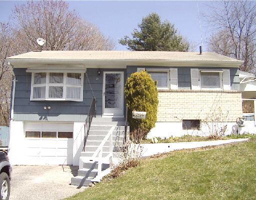 21 Berkshire Road Ansonia, CT 06401 - Photo 1 of 1 a front view of a house with a yard