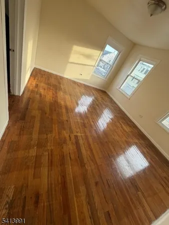 a view of an empty room and wooden floor