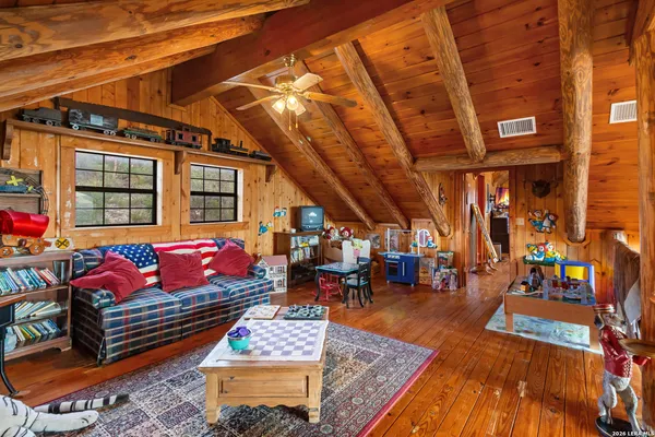 a bedroom with furniture and a large window