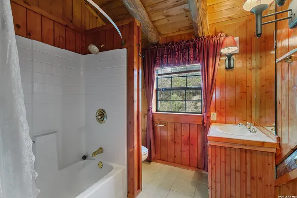 a bathroom with a sink mirror and a shower