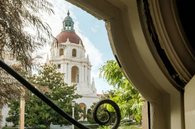 a living room with furniture floor to ceiling window and a fireplace
