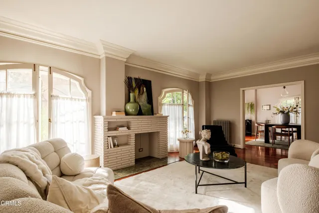 a living room with furniture and large windows