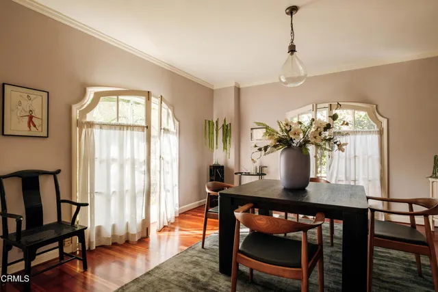 a view of a dining room with furniture and wooden floor