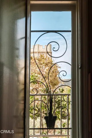 a dining room with furniture a chandelier and wooden floor