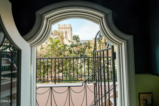 a bedroom with a bed and a dresser with wooden floor