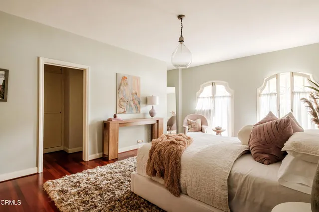 a living room with furniture and a floor to ceiling window
