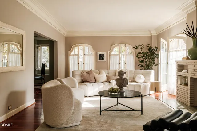 a living room with furniture fireplace and flat screen tv