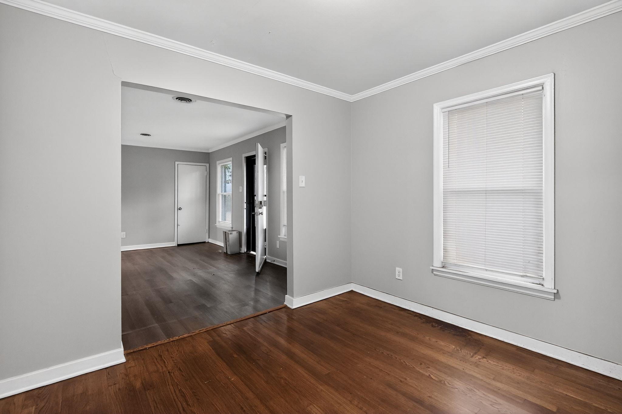 177 East Raines Road Memphis, TN 38109 - Photo 10 of 32 Unfurnished room with crown molding and dark wood-type flooring