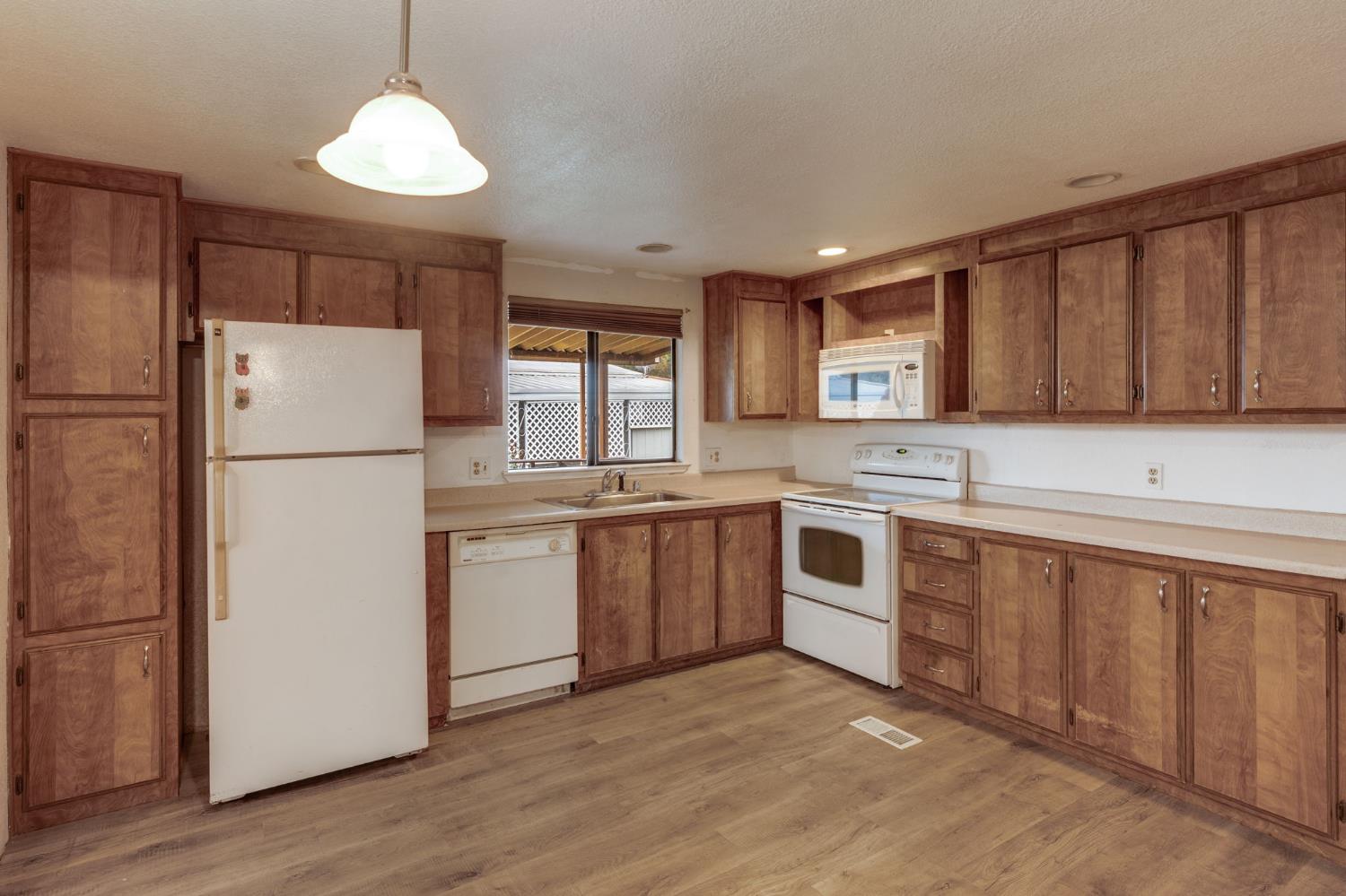 443 Royal Crest Circle Rancho Cordova, CA 95670 - Photo 12 of 28 a kitchen with stainless steel appliances granite countertop a refrigerator a stove a sink and a microwave