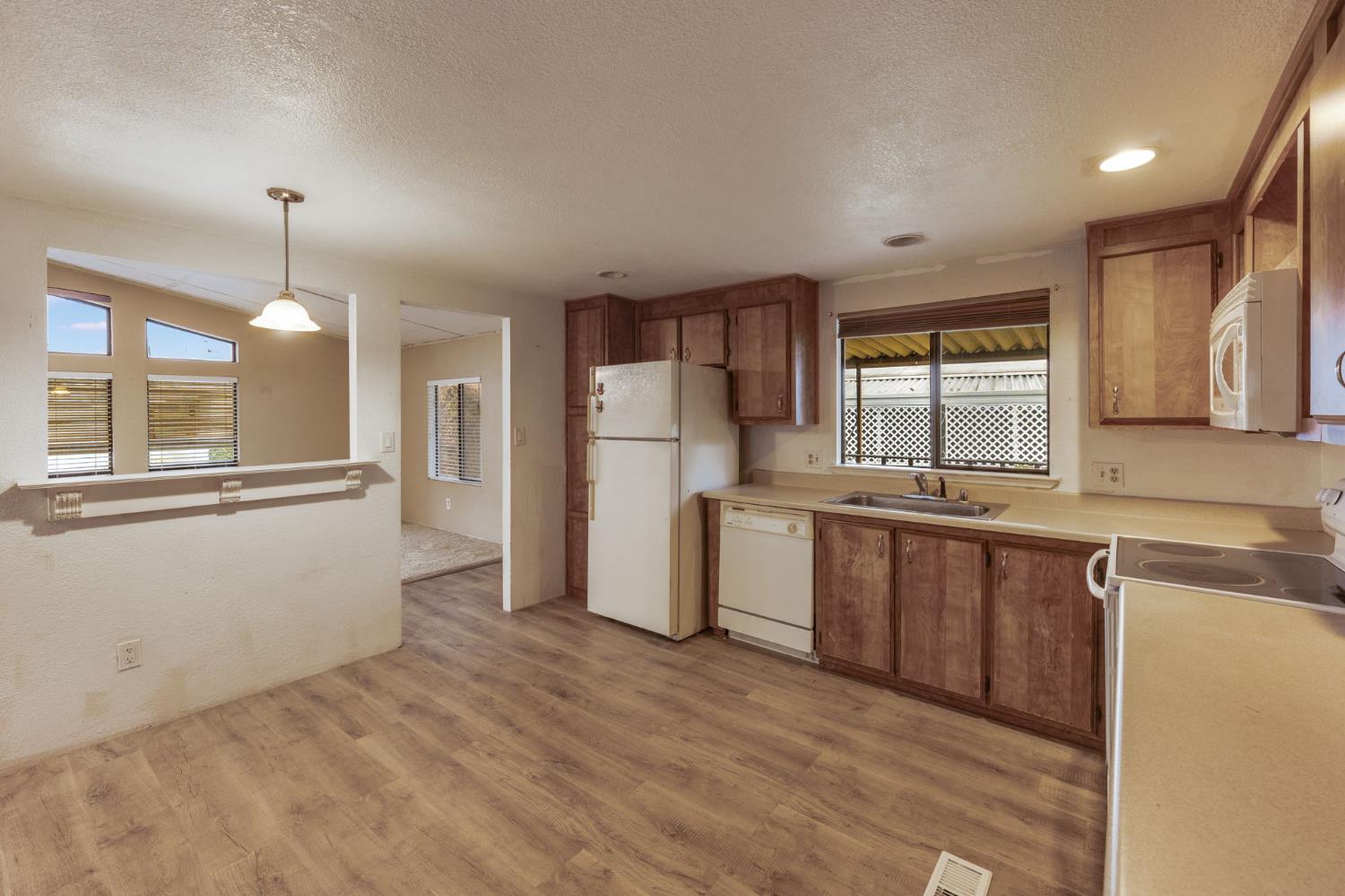 443 Royal Crest Circle Rancho Cordova, CA 95670 - Photo 13 of 28 a kitchen with granite countertop a refrigerator and a sink