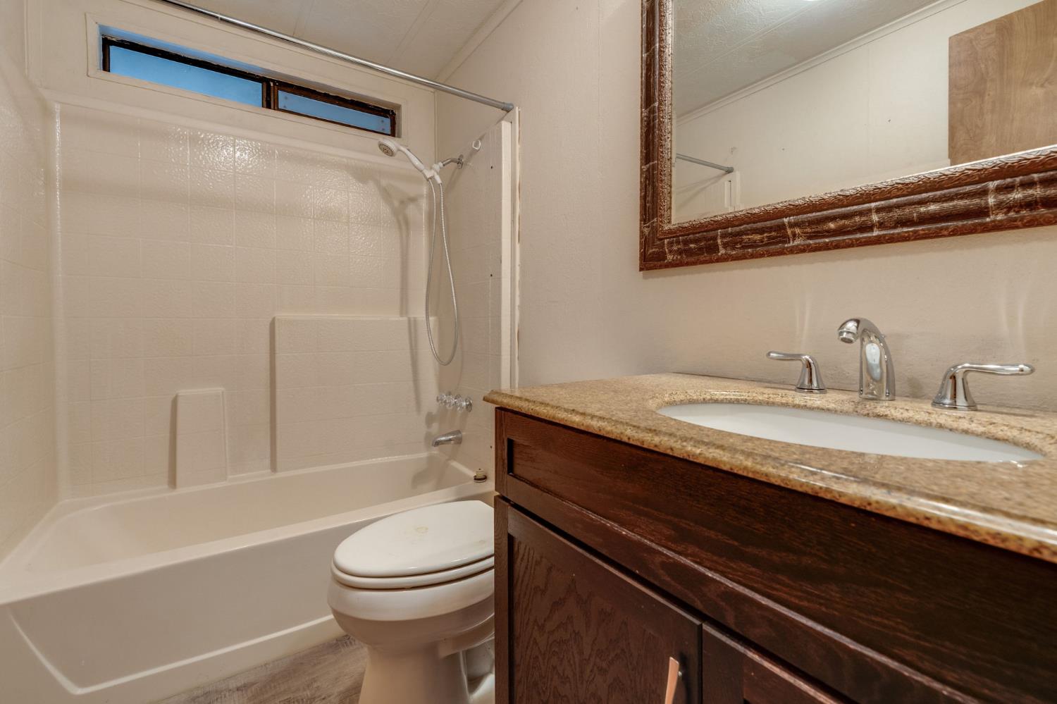 443 Royal Crest Circle Rancho Cordova, CA 95670 - Photo 22 of 28 a bathroom with a granite countertop sink toilet and shower