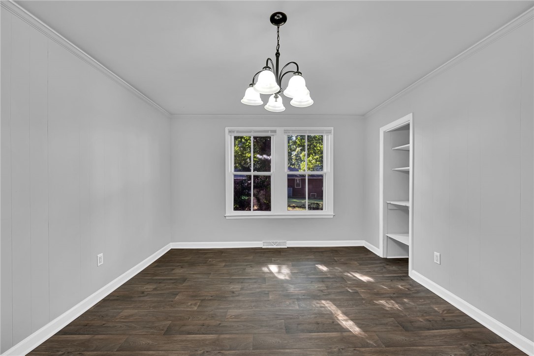 403 Lewis Street Anderson, SC 29624 - Photo 7 of 35 Rich wood-inspired flooring pairs with crisp crown molding in this versatile dining area.