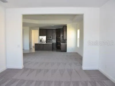 a view of a small space with wooden floor and a window
