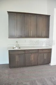 a kitchen with stainless steel appliances granite countertop a sink a stove and a refrigerator with wooden floor