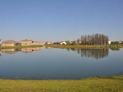 a living room with furniture a large window and a chandelier