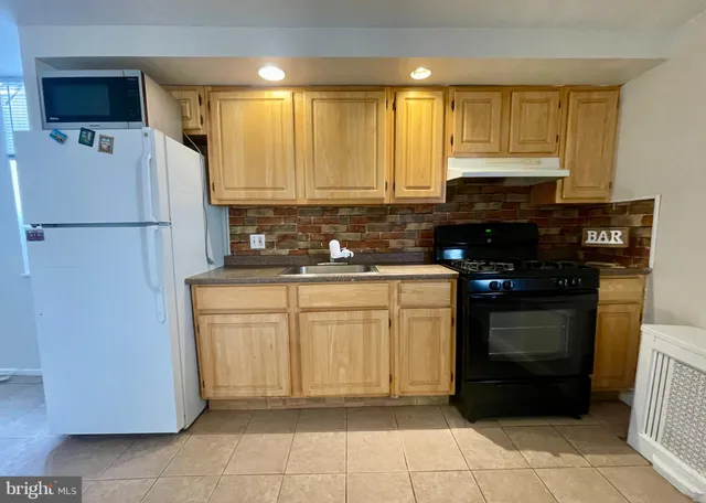 a kitchen with a refrigerator and a sink