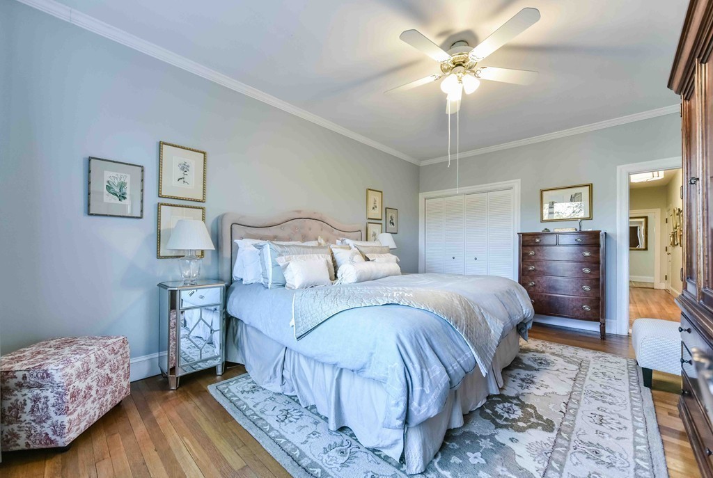 123 Winthrop Road, Unit 1 Brookline, MA 02445 - Photo 8 of 13 a bedroom with a bed and a chandelier