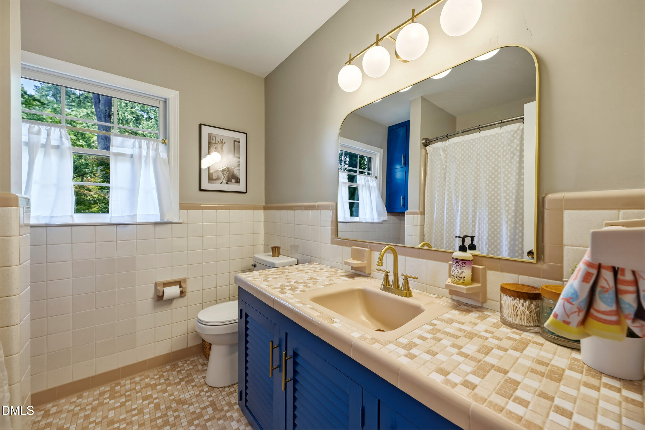 3726 Swift Drive Raleigh, NC 27606 - Photo 25 of 40 a bathroom with a granite countertop sink and a mirror