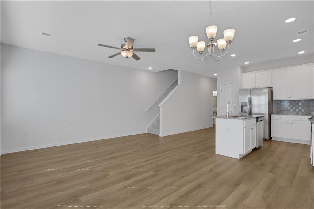 102 Jaxton Street Hoschton, GA 30548 - Photo 14 of 36 a view of kitchen with cabinetry and ceiling fan