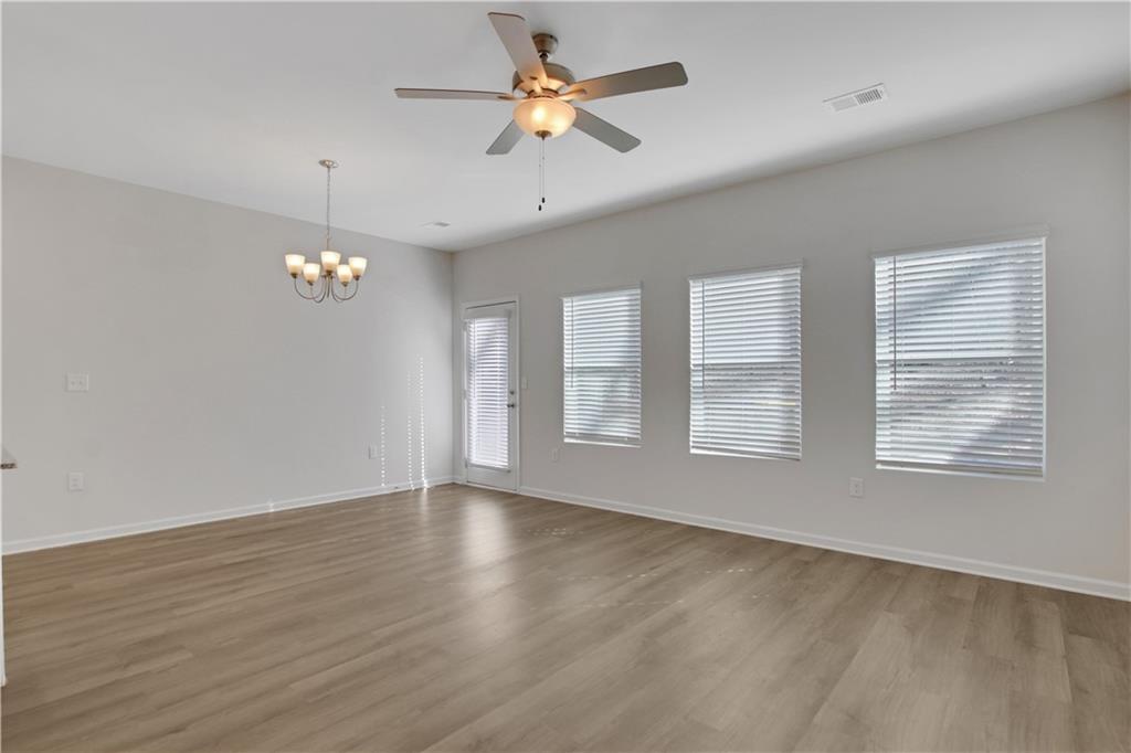 102 Jaxton Street Hoschton, GA 30548 - Photo 16 of 36 wooden floor in an empty room with a window