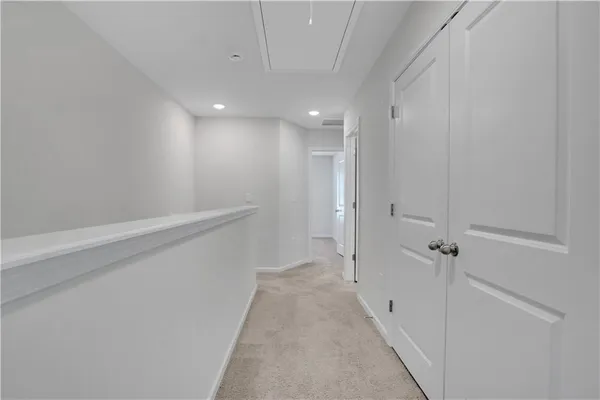 a view of a hallway with white walls