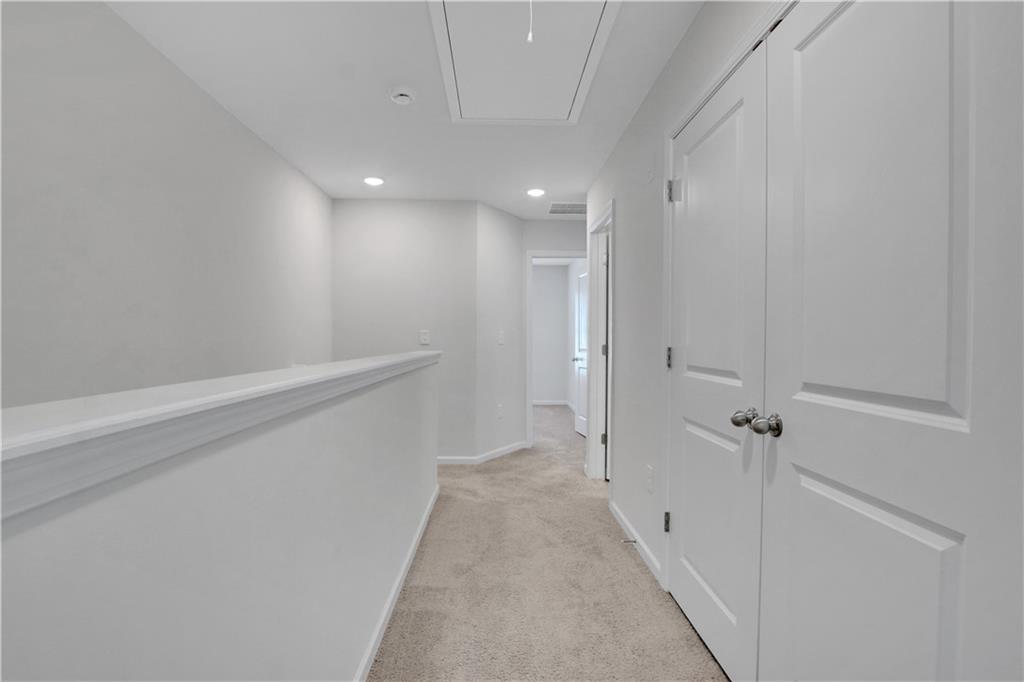 102 Jaxton Street Hoschton, GA 30548 - Photo 19 of 36 a view of a hallway with white walls